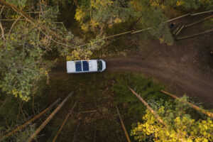 drone shot from above of camper van in the woods